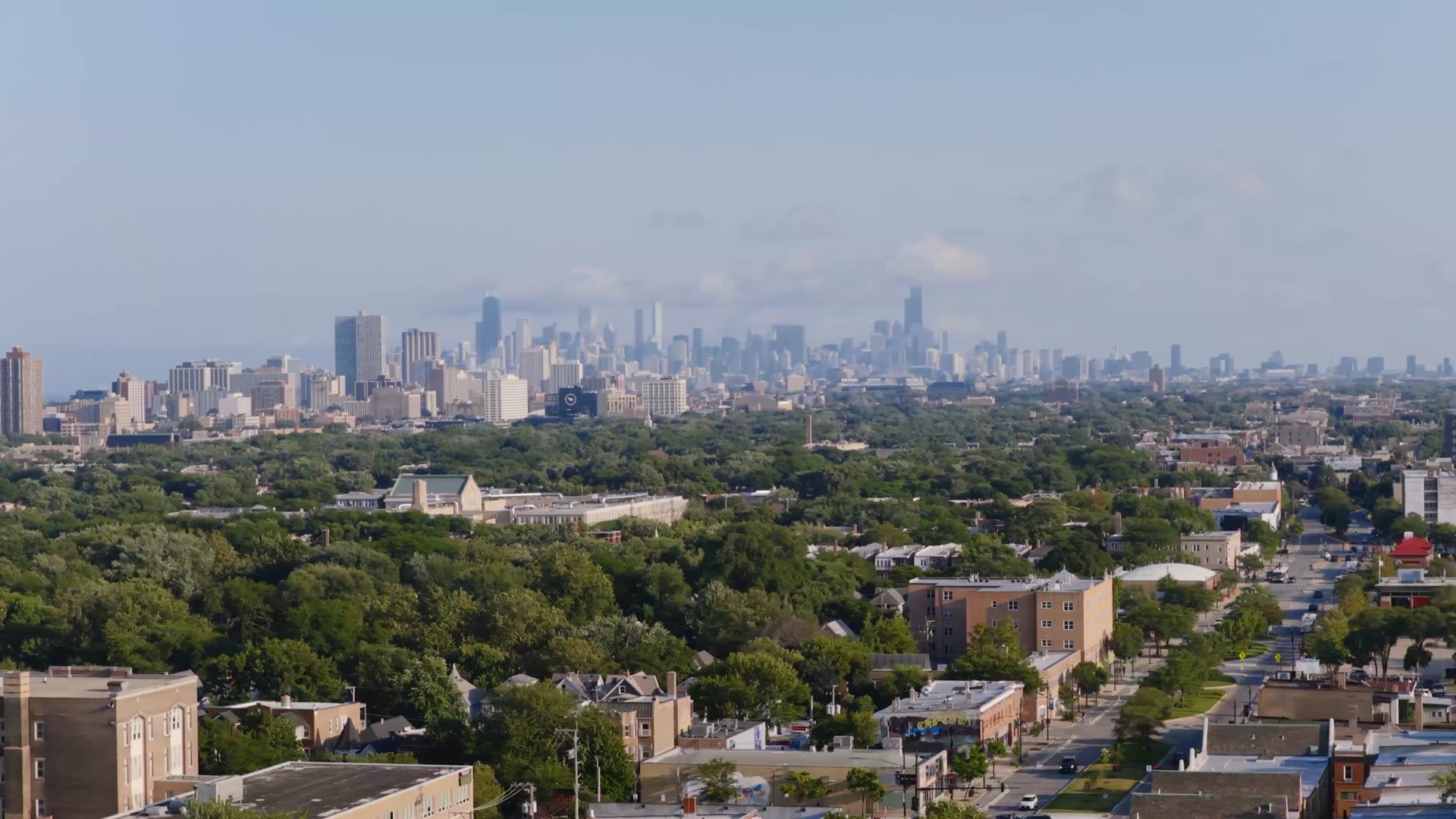 Aerial view of Chicago neighborhoods with the downtown skyline on the horizon